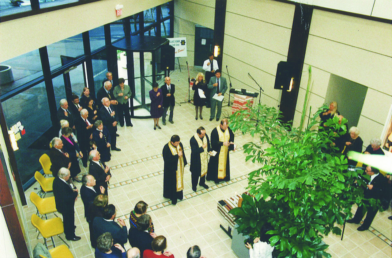Group of 3 Priests conducting a mass for UNA members inside The UNA building