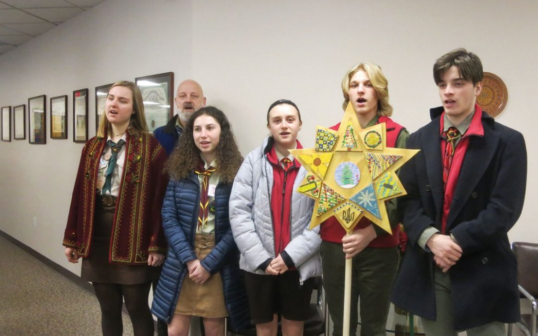 Young carolers visit UNA Home Office