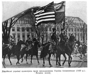Men riding on horses carrying the Ukrainian and American flags at 1933 Detroit Protest