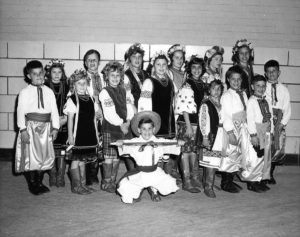 Children dressed in Ukrainian Dance costumes and posing for group photo