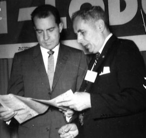 US President Nixon reading a brochure with UNA Member