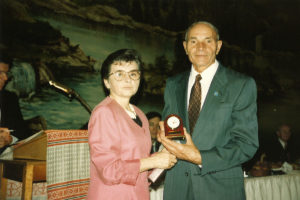 1994 UNA Jersey District 100th Anniversary Man receiving desk clock