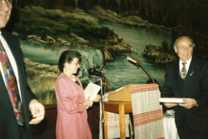 1994 UNA Jersey District 100th Anniversary Man receiving a book