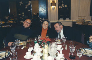 2005 Christmas party 3 people posing for picture at table