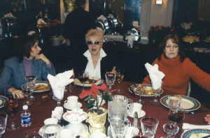2005 Christmas party 3 women talking at a table